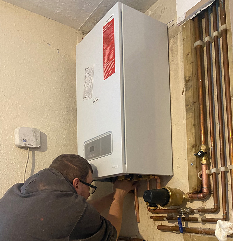 Gas Safe engineer servicing a Glow-worm boiler